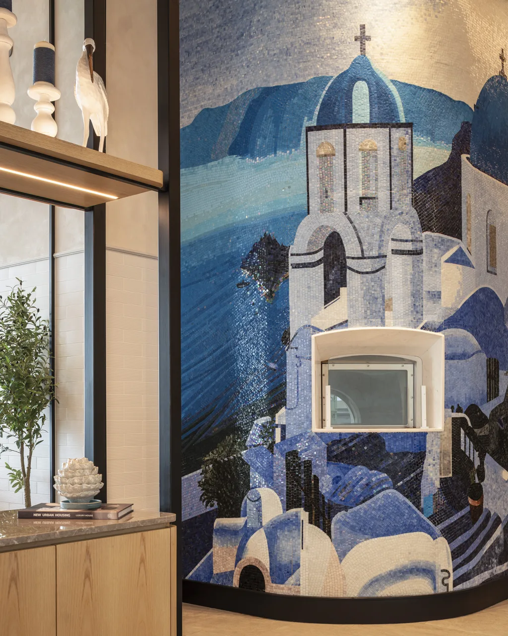 Textured blue-tile feature wall behind banquette, Level 22 restaurant