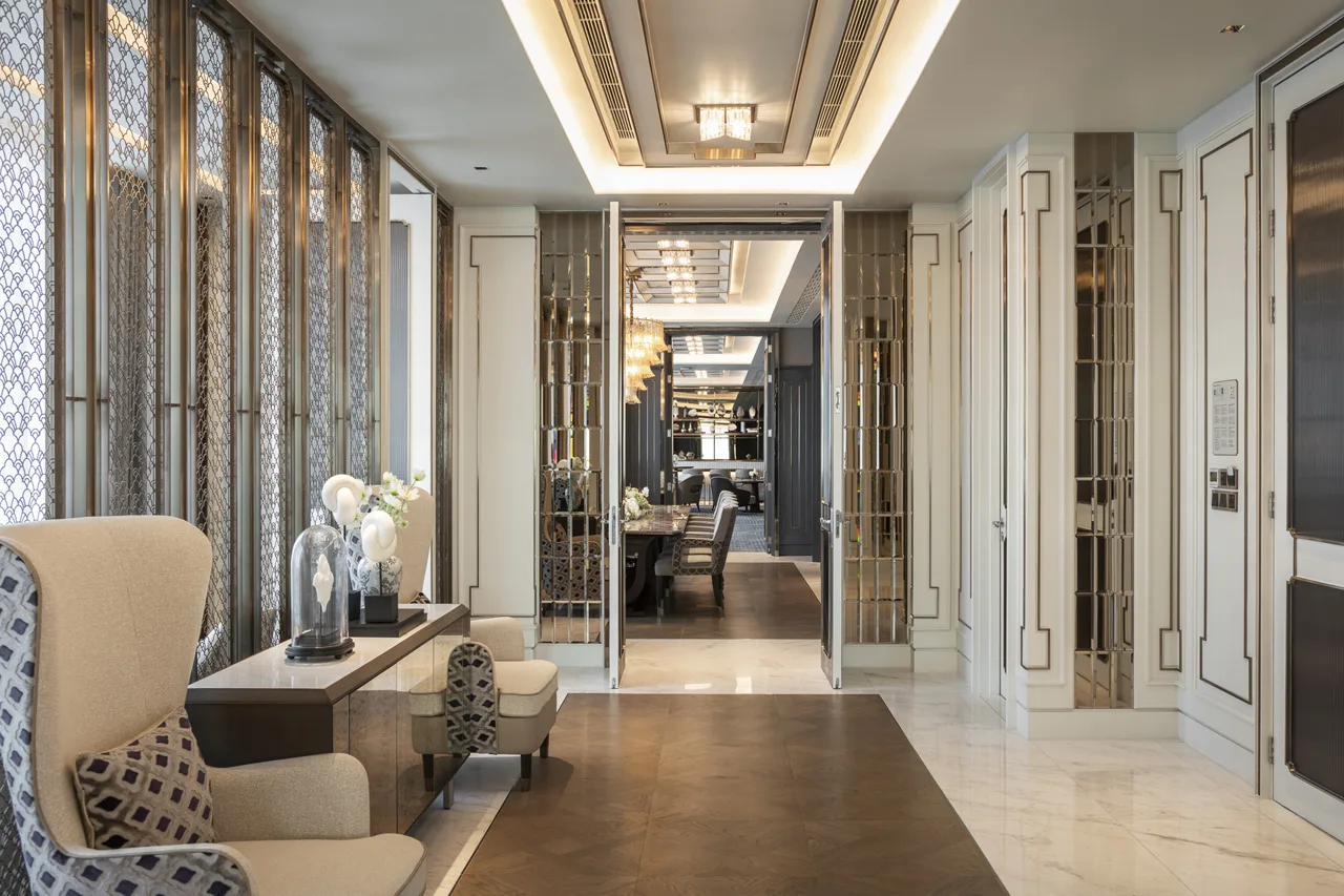 Suite • Lift-style Foyer Suite foyer – hallway chandeliers & mirrored panels